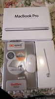 sealed MacBook Pro bundle items in original packaging