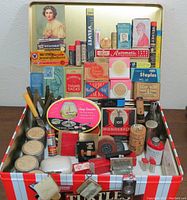Top view showing entire contents of vintage advertising and collectible tin including cards, boxes, and small novelties.