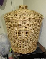 Wicker basket with lid and handle, shown upright covered with lid