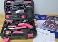 Photo of 15-piece Apollo household tool kit with case, including various hand and power tools in pink and black.