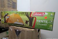 Photo of Coleman 3-person tent boxed with packaging graphics and branding.