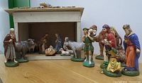Photo showing the full nativity set arranged with barn and figurines including Mary, Joseph, animals, shepherd, and wise men
