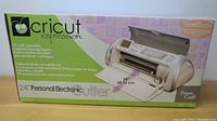 Front of the box showing the Cricut Expression 24" Personal Electronic Cutter, highlighting 12 x 24 inch cutting capability, timesaving modes, and creative functions.