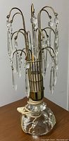 Lead crystal table lamp showing the base, brass arms, and hanging lead crystal prisms