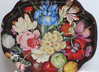 Close-up of metal tray with detailed vibrant flowers painted, including irises, daisies, tulips, poppies, and fruits.