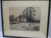 Framed black and white print of a farmhouse and trees with sheep and a cart in a rural setting