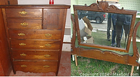 Front view of antique wooden bureau showing six drawers with original brass hardware and a small door on the upper right side.
