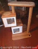 Overall view of the cat tree showing two stacked cube hideouts with transparent windows, a circular scratching post beside them, and a top platform.