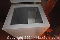 Top view of open Koolatron chest freezer showing clean interior with internal compartment divider.