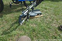 CRAFTSMAN hand mitre saw resting on grass showing full tool with frame, blade, adjustable angle base, and handle.