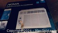 Front view of Noma 5000 BTU window air conditioner in box showing model and cooling capacity.
