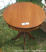 Top view of the round tabletop showing wood grain and smooth finish.