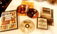 PlayStation 2 game case for Grand Theft Auto and four game discs including Sims City 2000 DVD and two other discs