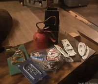 Entire lot displayed on table showing multiple hardware pieces and vintage tins