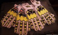 Four pairs of new Cut-X work gloves laid out showing yellow and black protective design with white fabric.