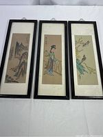 Three framed Chinese silk paintings showing different scenes: landscape, woman, birds.