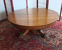 Top view of the round oak coffee table showing polished wood surface and edge detail.