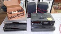 Photo showing various audio and video components including Toshiba VHS/DVD combo player, Sony 5-CD changer, JVC cassette deck, Yamaha CD player, two speakers, and a box of cables.