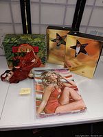 Photo showing all items together: Farrah Fawcett puzzle box, Pumba cookie jar, and two Barbie doll boxes.