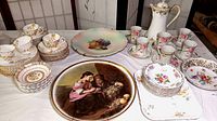 Full view of all teacups, saucers, dessert plates, and decorative plates arranged on table