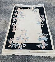 Full view of the handwoven Oriental area rug showing the floral pattern and color scheme.