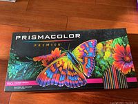 Closed box of Prismacolor Premier 150 colored pencils showing butterfly and flower artwork on the lid.