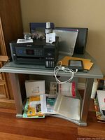 Printer, Kindle, papers and supplies on grey media table