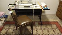 Full view of the sewing table and chair showing setup and environment with contents on table not included