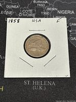 Obverse side of the 1858 Flying Eagle penny showing the flying eagle design and labeled '1858 USA F'.