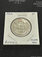 Front side of 1952 Canadian 50 cents silver coin showing crowned Canadian shield.