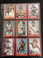 Front of nine individual 1973-74 NHL O-Pee-Chee trading cards featuring players from various teams including New York Islanders, Kings, Rangers, Red Wings, Bruins, and North Stars.