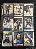 Front view of nine Toronto Maple Leafs hockey cards in a display sleeve showing players in action and portrait shots