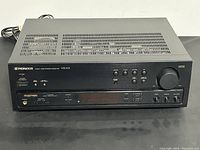 Front and top view of black Pioneer VSX-305 stereo receiver showing power buttons, input controls and ventilation grills on top.
