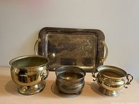 All items together showing the three pots and single tray with gold colored handles, one handle loose.