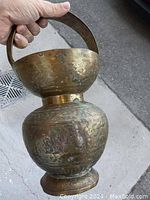 Side angle showing aged brass Patina and handle attached to the water pot