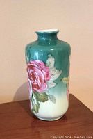 Front view of the porcelain vase showing green to white gradient with large hand painted pink and red roses.