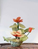 Full view of bonsai tree sculpture with rose quartz flowers and jade leaves in jade base.