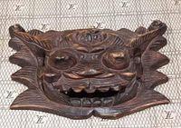 Front close-up of the hand carved Chinese NUO wood mask showing detailed facial carving and texture.