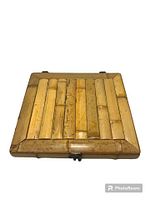 Closed vintage bamboo box with visible bamboo strips on top and metal clasp.