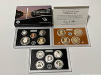 Coins and certification in original protective packaging with tray, certificate, and outer box.