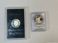 Both coins shown side by side; one in graded PCGS holder, one in original proof packaging.