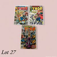 Photo showing three Thor comic books from Marvel Comics Group with colorful action-packed covers and clear title text