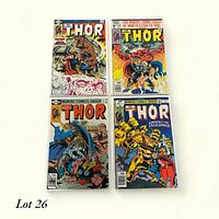 Four Thor comic books displayed in a 2x2 arrangement, showing covers clearly with distinct artwork and titles.