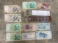 Overview of Israeli banknotes, Egyptian banknotes, various coins, and Israel 30th Anniversary Official Mint Set.