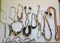 Full layout of all necklaces and matching earring pairs showing variety of materials and styles.