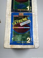 Close-up photo showing partial unopened packaging of 1995 Topps Stadium Club Extreme Series 1 and Series 2 football cards with clear branding and series number.