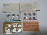 Full view of all coin sets, Treasury Department envelopes and certification cards.