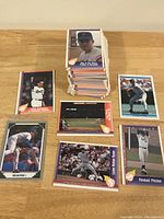 Overall stack of Nolan Ryan baseball cards and close-up shots of individual cards from various angles showing player action and card details.