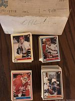 Overhead photo showing multiple stacks of OHL hockey cards along with the labeled cardboard box indicating the set is from 1990-1991 and numbered 1-400.