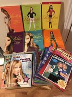 Image showing the full collection including Sara Shepard books and multiple colorful young adult paperback novels from Disney series like Hannah Montana and Lizzie McGuire fanned out on a table.
